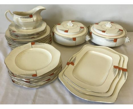 A c1930's Art Deco part dinner service with orange sunburst decoration. Comprising 2 lidded tureens, a large sauce boat, 3 re