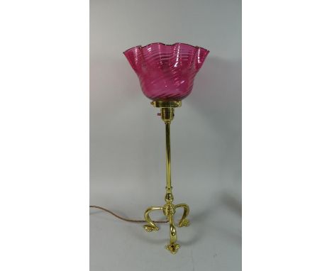 A Benson Style Table Lamp with Flared and Wavy Cranberry Glass Shade, On Three Supports having Trefoil Feet. 52cms High 