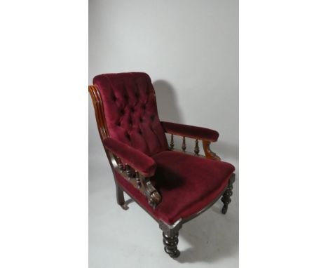 A 19th Century Gentlemans Button Backed Red Velvet Upholstered Armchair. Scrolled and Moulded Decoration, Turned Legs Culmina