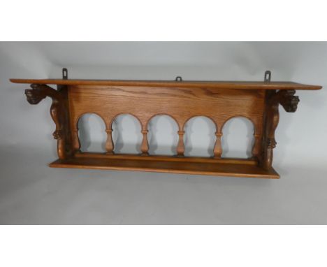 A Continental Oak Hanging Wall Shelf with a Plank Top over an Open Multi Arched Back Flanked by Two Carved Dragons. 120x35x42