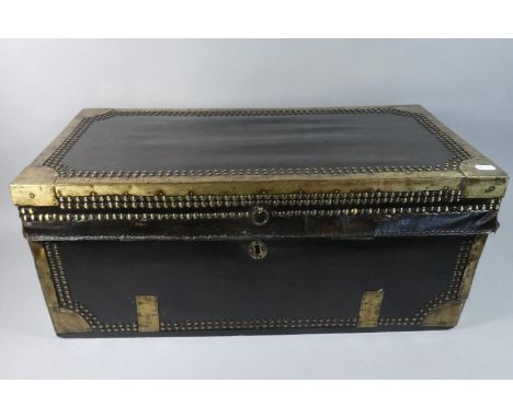 An Early 19th Century China Trade Leather Covered Camphor Wood Trunk with Brass Bound and Brass Studwork Decoration. 64x32x28