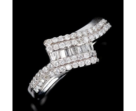 A modern 9ct white gold diamond cluster crossover ring set with baguette and round brilliant-cut diamonds, total diamond cont