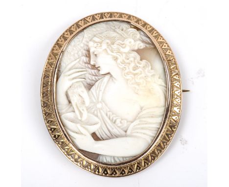 A Victorian shell cameo brooch, depicting Hebe feeding eagle Zeus, relief carved with unmarked rose metal engrave frame, over