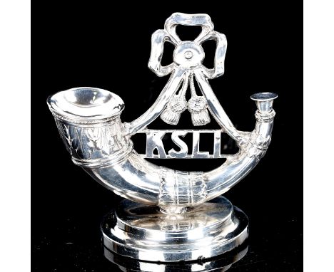 An early 20th century silver King's Shropshire Light Infantry British Army Regiment novelty desk lighter/ashtray, with faded 