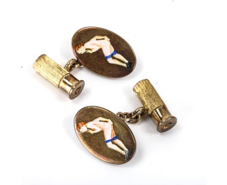 A pair of late 20th century silver-gilt gentleman's novelty cufflinks, with enamel nude lady and shotgun cartridge decoration