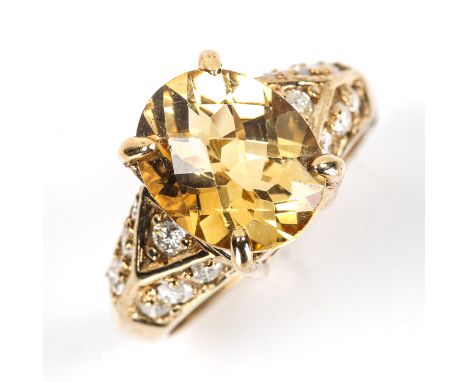 A modern 9ct gold citrine and diamond dress ring, set with oval rose-cut citrine and modern round brilliant-cut diamonds, tot