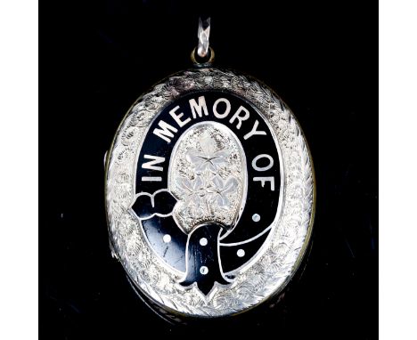 A Victorian enamel memorial locket pendant, unmarked yellow metal settings with black enamel In Memory Of garter and engraved