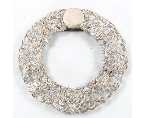 A Chinese export silver photo frame, possibly by Tuck Chang & Co circa 1900, circular form with relief embossed and pierced c