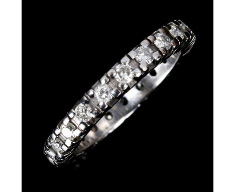 An unmarked white gold diamond eternity ring, set with modern round brilliant-cut diamonds, total diamond content approx 0.75
