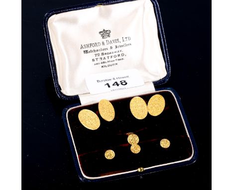 An early 20th century 9ct gold dress set, comprising pair of cufflinks, and 4 dress studs, engraved leaf decoration, maker's 