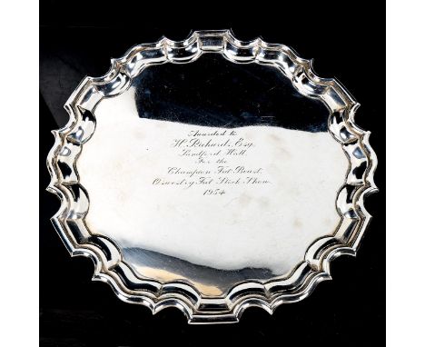 A George VI silver salver, scalloped rim with scrolled acanthus leaf feet, by G Bryan & Co, hallmarks Birmingham 1945, diamet