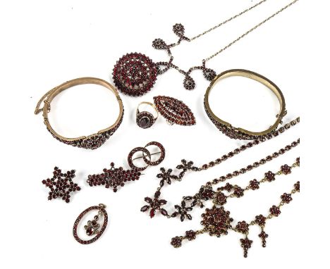 A large group of Bohemian garnet jewellery, including hinged bangles, pendants, brooches, necklaces and ringsLot sold as seen
