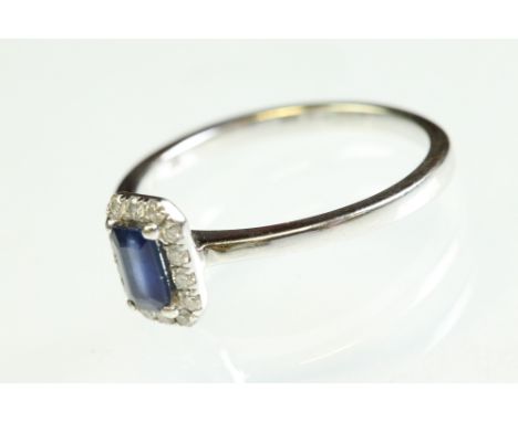 Sapphire and diamond 9ct white gold cluster ring, the rectangular step cut sapphire measuring approx 5mm x 3mm, claw set, sma