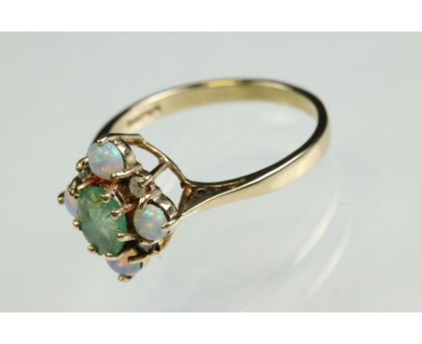 Emerald, opal and diamond 9ct yellow gold ring, the oval mixed cut emerald measuring approx 6mm x 4.5mm, four small round cab