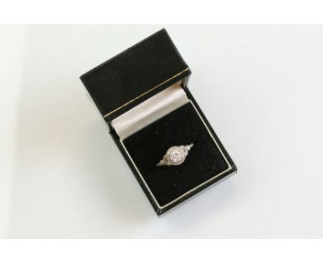 Diamond platinum ring, the principal round brilliant cut diamond weighing approx 0.85 carat, claw set, small round brilliant 