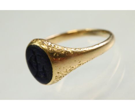 Mid 19th century lapis lazuli unmarked yellow gold signet ring, the oval lapis lazuli panel measuring approx 9mm x 7mm, engra