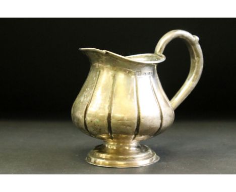 Russian silver cream jug raised on stepped circular foot, ribbed body, makers mark AM, height approx 11cm 