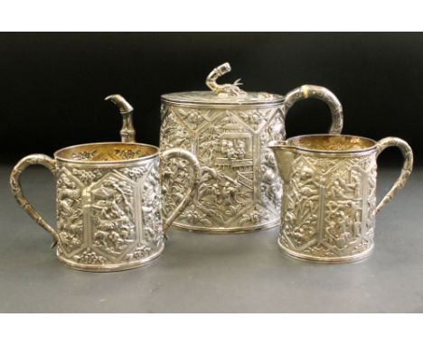 Late 19th century three piece silver tea service comprising teapot, milk jug and sugar bowl, heavily repousséd body depicting