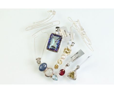 Collection of silver pendants to include kyanite, moonstone and blue topaz pendant; mystic quartz pendant; ruby and white zir
