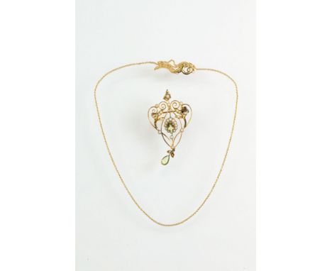 Edwardian peridot and pearl openwork sinuous pendant, oval mixed cut peridot to centre with split seed pearl surround, split 