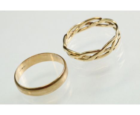 9ct yellow gold wedding band, width approx 4mm, ring size P½; together with a 9ct yellow gold interwoven ring, width approx 4