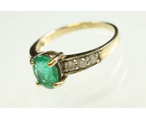 Emerald and diamond 9ct yellow and white gold set ring, the oval mixed cut emerald measuring approx 8mm x 6mm, approx 1.0 car