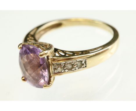 Amethyst and white topaz 9ct yellow gold ring, the oval mixed chequerboard cut amethyst measuring approx 10mm x 8mm, claw set