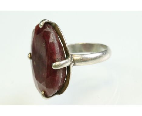 Ruby white metal ring, the oval mixed cut ruby measuring approx 26mm x 18.5mm, claw set, ring size T 