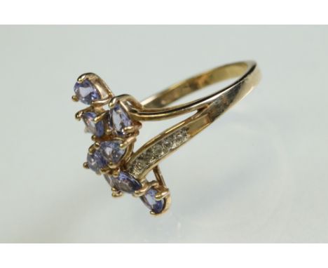 Tanzanite and diamond 10ct yellow gold ring, eight pear shaped tanzanite, five small round brilliant cut diamonds set to each