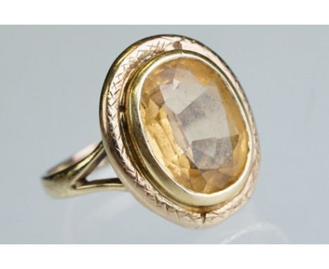 Citrine yellow metal ring, the oval mixed cut citrine measuring approx 11.5mm x 9mm, rubover set, v shaped shoulders, ring si