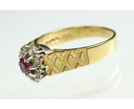Ruby and diamond 18ct yellow and white gold set cluster ring, the round mixed cut ruby diameter approx 4mm, claw set, small r