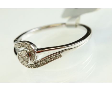 Diamond 9ct white gold ring, four small eight cut diamonds to the centre, the crossover shoulders set with eighteen small rou