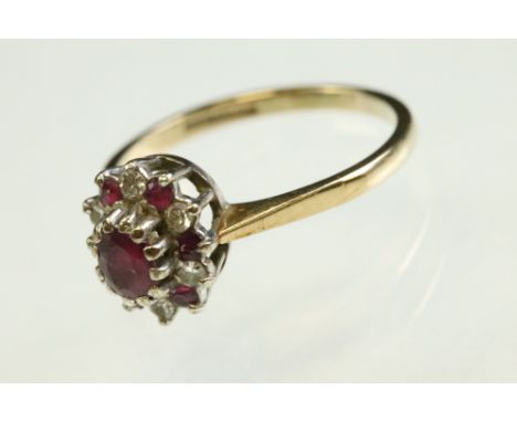 Ruby and diamond 9ct white gold cluster ring, the oval mixed cut ruby to centre measuring approx 4mm x 3.5mm, alternate ruby 