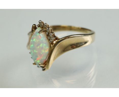 Ethiopian opal and diamond 14ct yellow gold ring, the marquise cabochon cut white opal displaying indigo, blue, green and red