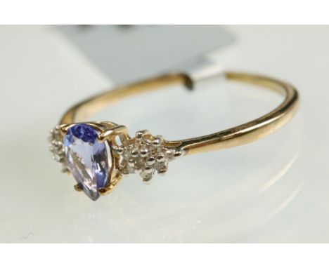 Tanzanite and diamond 9ct yellow gold ring, the pear shaped tanzanite measuring approx 7mm x 4.5mm, claw set, eight small rou