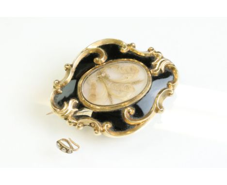 Early Victorian enamelled yellow metal mourning brooch, the glazed compartment to the centre with hair and filligree, black e