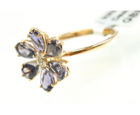 Iolite and diamond 9ct yellow gold flower head ring, seven small round eight cut diamonds to the centre, six pear shaped mixe