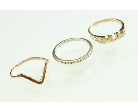 9ct gold 'Mum' ring, size S; 10ct rose gold wishbone ring, size U; together with a 9ct white gold wedding band, size R½ (3) 