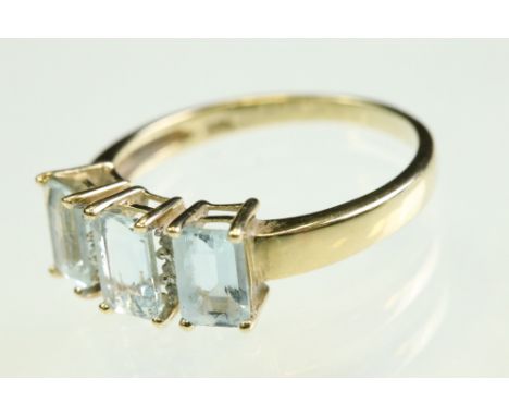 Aquamarine 9ct yellow gold ring, three rectangular step cut aquamarine, measuring approx 6mm x 3.5mm, claw set, small round e