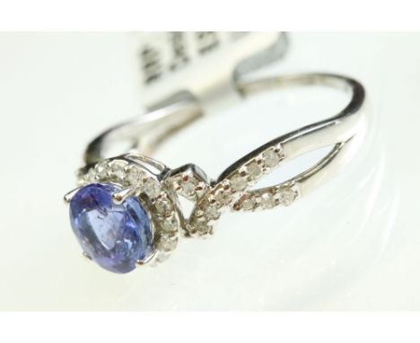Tanzanite and diamond 9ct white gold ring, the round cut tanzanite diameter approx 7mm, claw set, small round eight cut diamo
