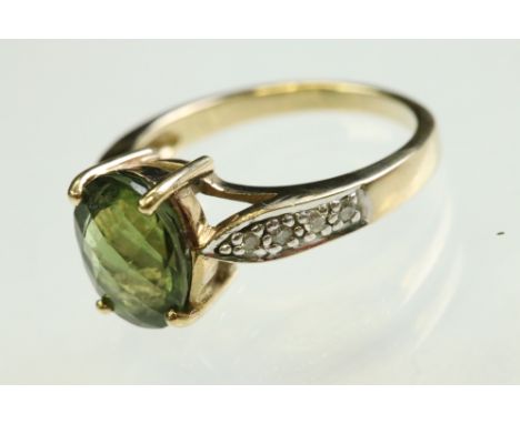 Green tourmaline and diamond 9ct yellow and white gold set ring, the oval chequerboard cut tourmaline measuring approx 10mm x