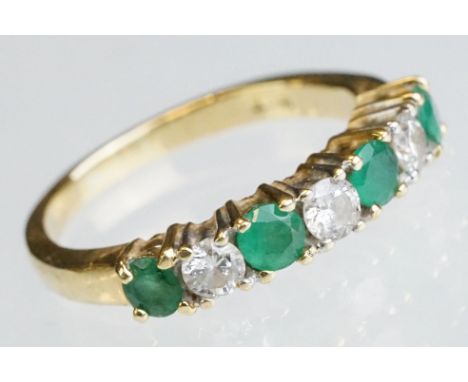 Emerald and diamond 18ct yellow gold ring, four small round mixed cut emeralds, three small round brilliant cut diamonds, cla