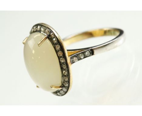 Moonstone and diamond gilt white metal cluster ring, the oval cabochon cut moonstone measuring approx 16mm x 12mm, four claw 