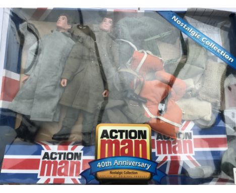 A box of vintage Action man clothing and accessories with two 40th anniversary dolls, one wearing a vintage escape officer un