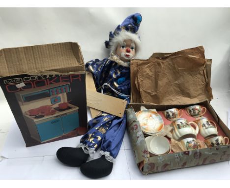 A boxed vintage child's tea set , a clown stringed puppet and a boxed Katie cordon bleu cooker