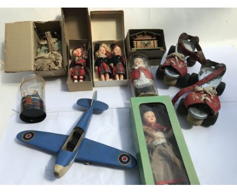A box of vintage boxed dolls and a musical box and a pair of vintage roller skates