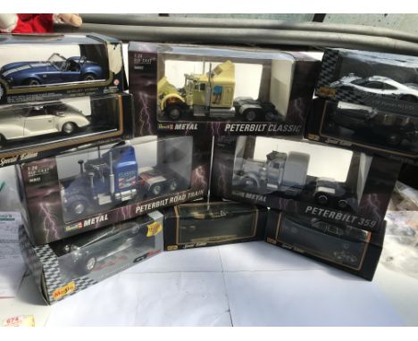A collection of boxed diecast vehicles including Maisto, Revell, . Peterbilt lorries 1:24 scale and vintage cars 1:18 scale