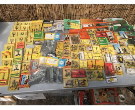 A collection of carded N gauge trackside accessories including lighting, signals , buildings etc