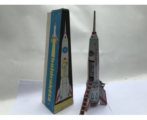 Russian boxed tinplate Rocket , in good working order, when nose cone hits an object rocket stands up and ladder comes down t