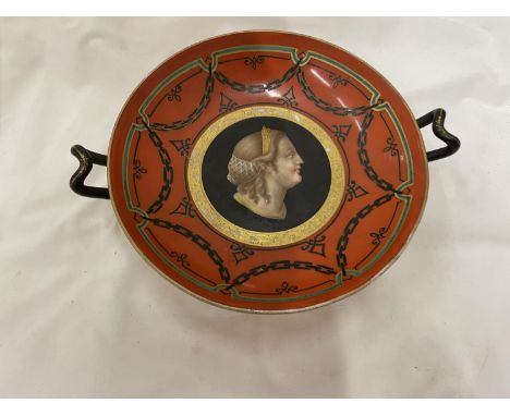 A VICTORIAN HANDLED 'TAZZA' DECORATED IN RED WITH A LADY'S PORTRAIT IN THE MIDDLE HEIGHT 9CM, DIAMETER 21CM 